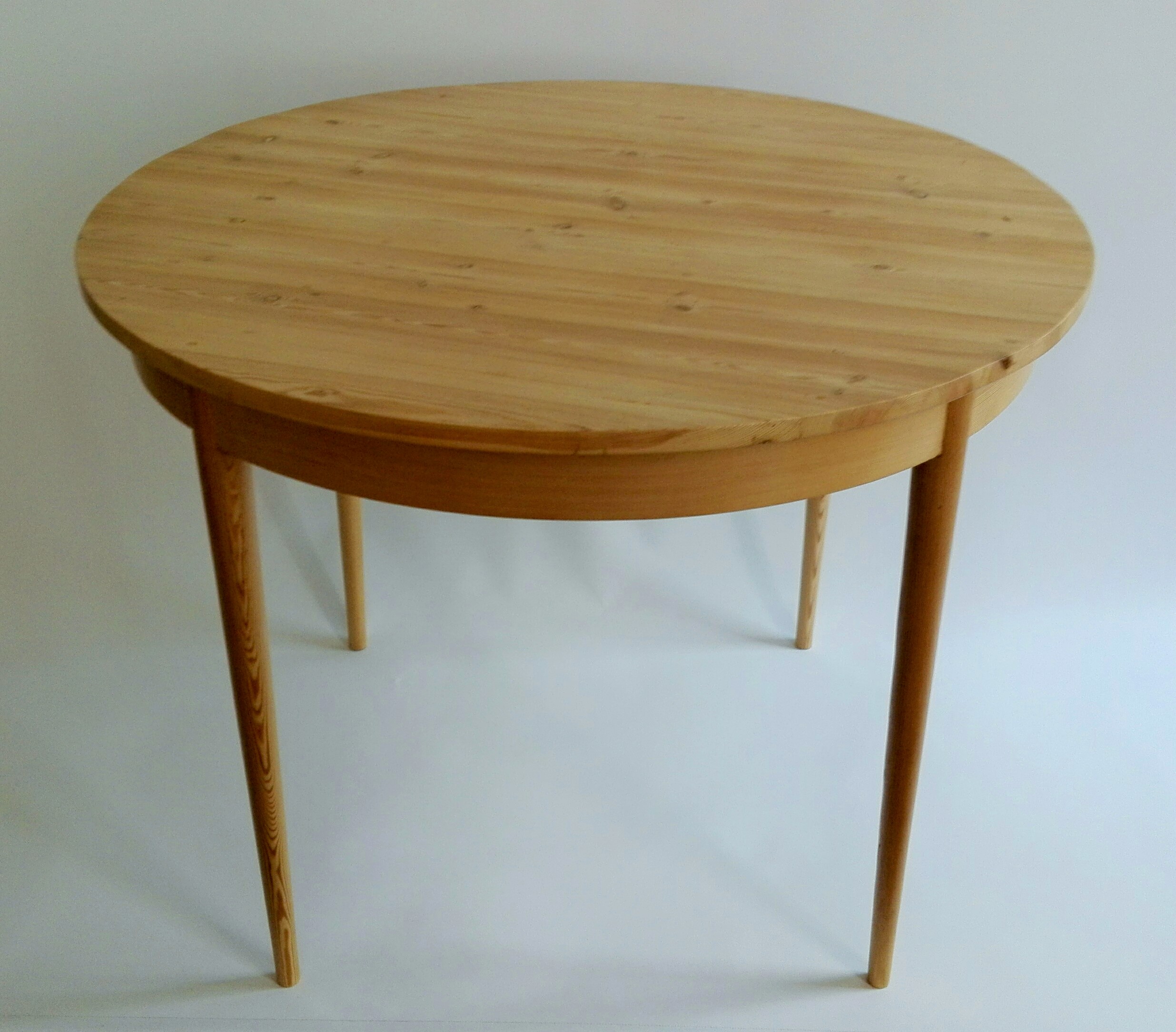 Round table created from bleached reclaimed 19th century Oregon pine